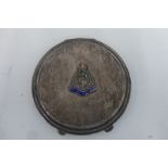 An H.M. silver powder compact with applied silver and enamel Royal Army Medical Corps badge.