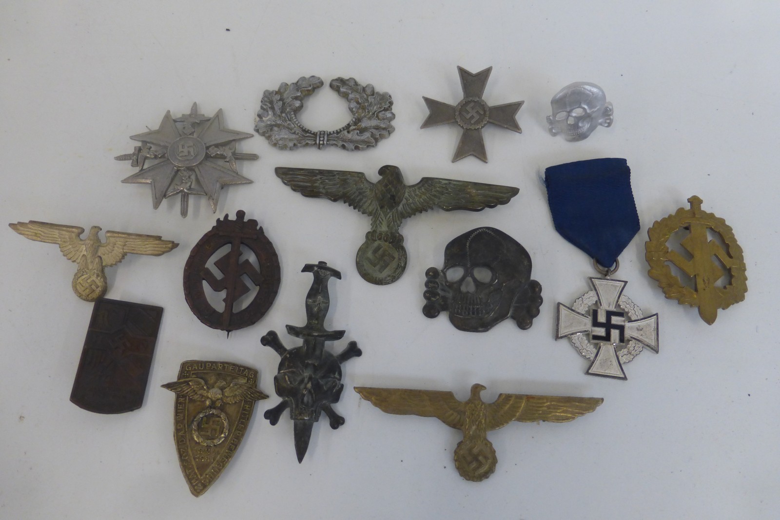 An assortment of genuine and reproduction Third Reich badges.