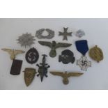 An assortment of genuine and reproduction Third Reich badges.