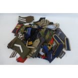 A large quantity of mixed military insignia.