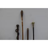 Three military style walking canes including leather covered and a cut shaft.