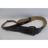 A black leather Sam Browne belt and cross strap.