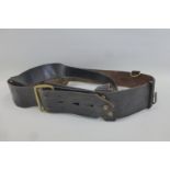 A black leather Sam Browne belt with cross strap.