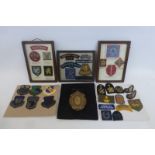 Six framed displays of military cloth badges.