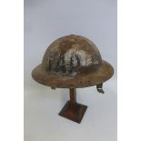 A WW2 British F.A.P. First Aid Post helmet with liner and damaged chin strap.