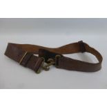 A brown leather military belt with brass snake buckle clasp.