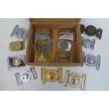 Fifteen military belt buckles.