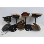 A box of ten military caps including the Irish guards, the Royal Artillery, the Royal Navy, the