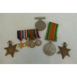 Four full size WW2 medals and an unassociated mounted dress miniature medal group including the