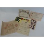 Red Cross certificates and medical badges.