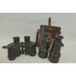 Two pairs of military field binoculars.