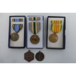 Five U.S.A. military medals including three boxed.