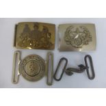 Four military belt buckles.