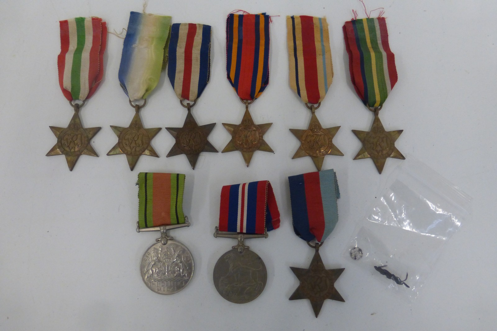 An assortment of nine WW2 medals with oak leaf and rosette.