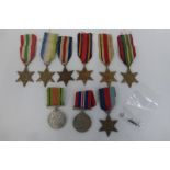 An assortment of nine WW2 medals with oak leaf and rosette.