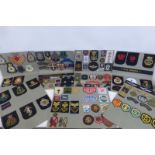 A folder of mainly military cloth badges.