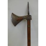 Possibly an Indian war axe, having copper figures overlaid on the steel head and mounted on a wooden
