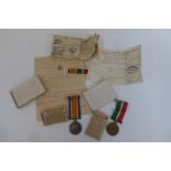 A WWI Mercantile Marine Medal pair named to George L. Wilson with associated paperwork and boxes.