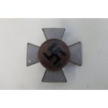 A WW2 Third Reich enamel lapel badge, having a black enamel swastika with a grey enamel cross.