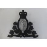 A Royal Canadian Corps of Signals metal door badge.