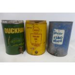 Three five gallon oil drums for Esso, Duckhams and Shell.