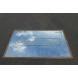 A large decorative wall mirror advertising Dom Perignon, 61 1/4 x 37 1/2".