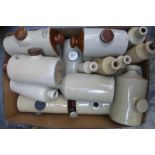 A large box of stoneware hot-water bottles and stoneware cider bottles.