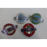 Three London Transport enamel cap badges, two of which are "Instructor"; also an "Underground"