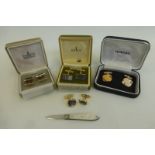 A silver mother of pearl fruit knife and an assortment of cufflinks.