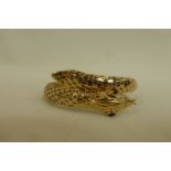 An 18ct gold bangle in the form of a snake with ruby eyes, stamped 750, approximate weight 25.3g.