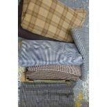 A quantity of assorted dressmaker's tweed material in various patterns.