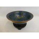 A Chinese cloisonne bowl decorated with flowers and foliage, with a blue and green ground,