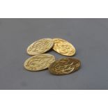 A pair of 18ct gold cufflinks in a tooled leather box, approximate weight 12.2g.