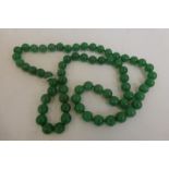 A green jade beaded necklace.