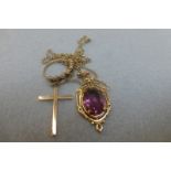 An assortment of 9ct gold jewellery including an amethyst pendant crucifix and a sapphire and