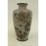 A Chinese cloisonne vase decorated with butterflies and flowers.