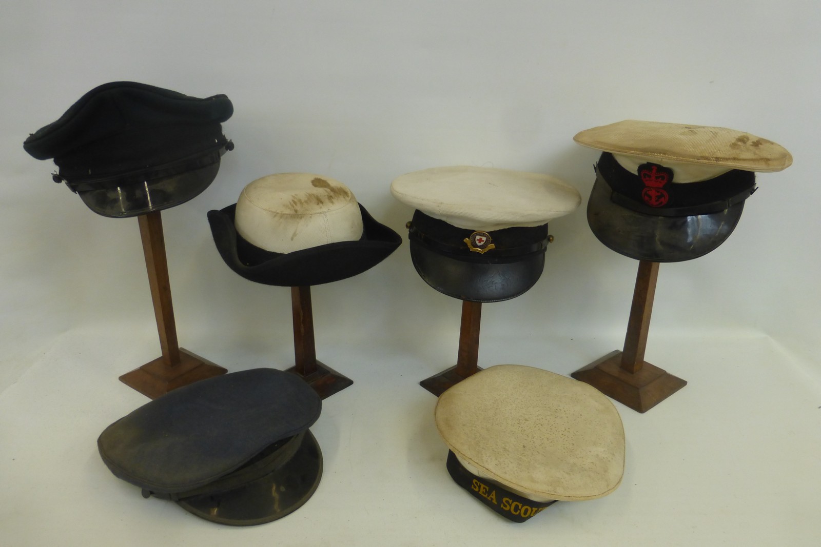 Six British Red Cross, army and navy caps and hats.
