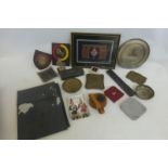 An assortment of military items including a map case, plaques, ashtrays, coasters etc.