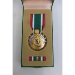 A Saudi Arabia Liberation of Kuwait medal as issued in green presentation box.