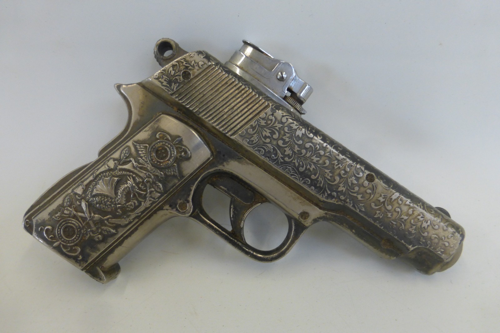 A novelty cigarette lighter in the form of an automatic pistol, approximately 6" long.