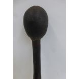 A South African knobkerrie, having a wooden shaft with a weighted end, approximately 23 1/4"