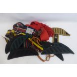 Four British Army stable belts and a sash, a small quantity of military bandsman's shoulder wings