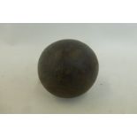 An antique cannon ball approximately 3" diameter.