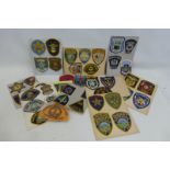 Fifty five embroidered cloth U.S.A. Police badges, mainly mounted on card.