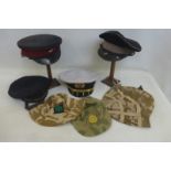 Eight military caps and hats.