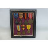 A framed display of seven full size Belgian medals including the Order of Leopold II and the Croix