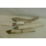 A Military Post 1953 heavy white plastic belt with brass buckle together with three military belts