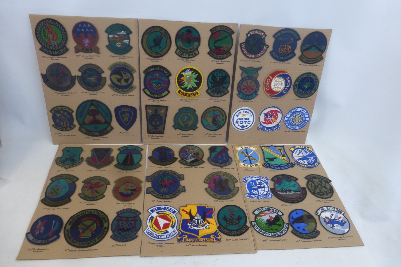 Fifty three United States Air Force embroidered cloth badges mounted on cards.