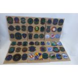 Fifty three United States Air Force embroidered cloth badges mounted on cards.