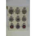A display of nine police and constabulary helmet badges, average size approximately 4 3/4 x 3 1/